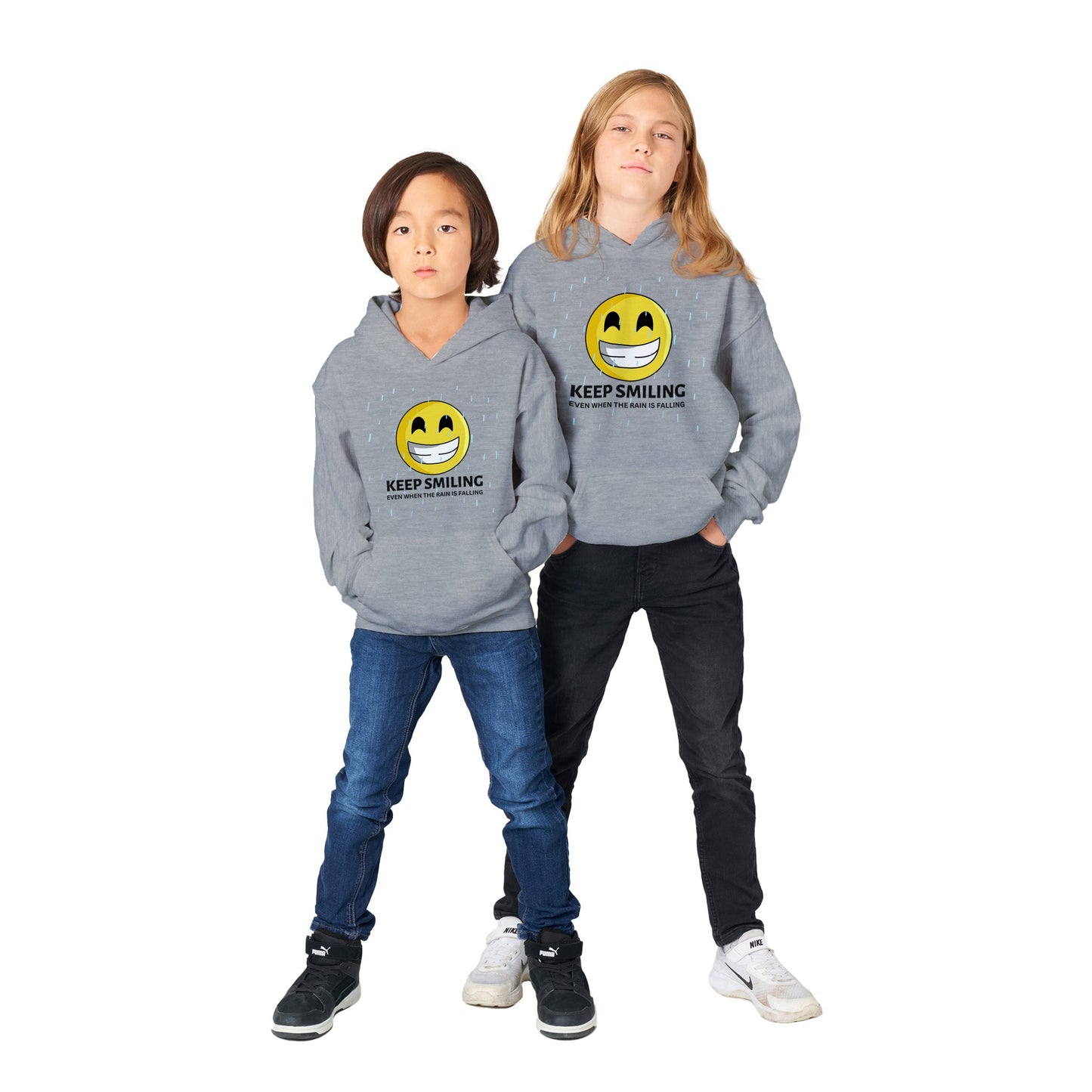 Inspirational Unisex kids Hoodie with a positive affirmation: "I Keep Smiling, even when the rain is falling". An image of an emoji smiling and drop of rain - grey