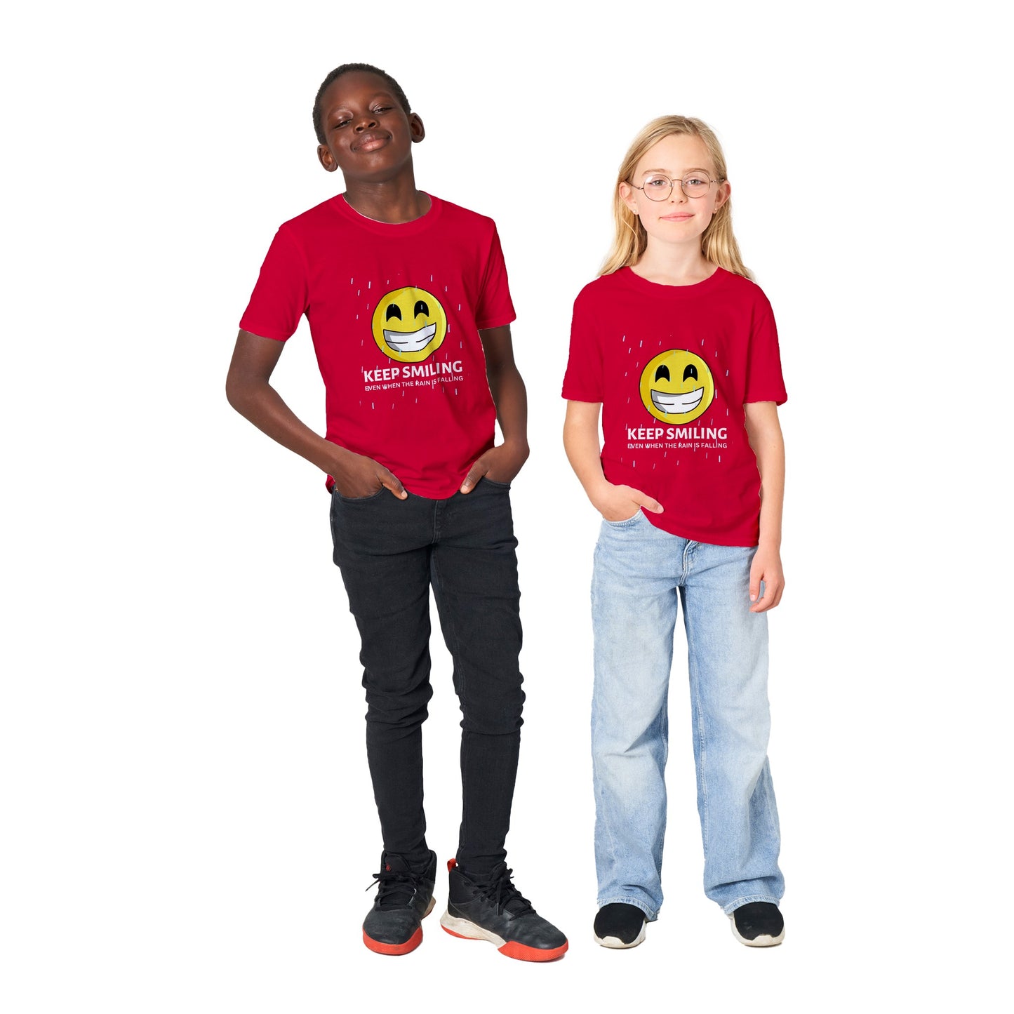Inspirational Kids T-Shirt with a positive affirmation: "I Keep Smiling, even when the rain is falling". An image of an emoji smiling and drop of rain - red tee