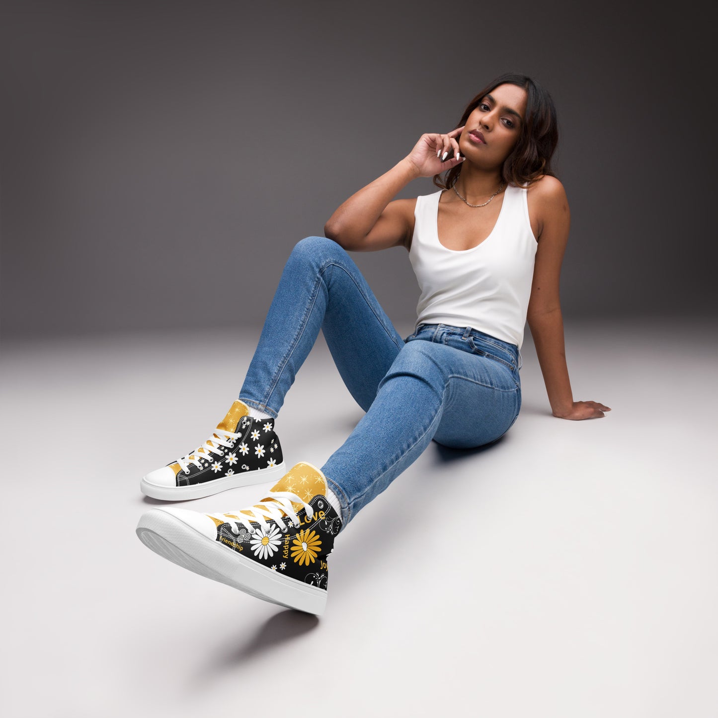 Women’s high-top Black canvas shoes whit yellow and white Daisy Flowers and swirls.  The shoes have inspirational words – "friendship," "joy," "love," and "happy"